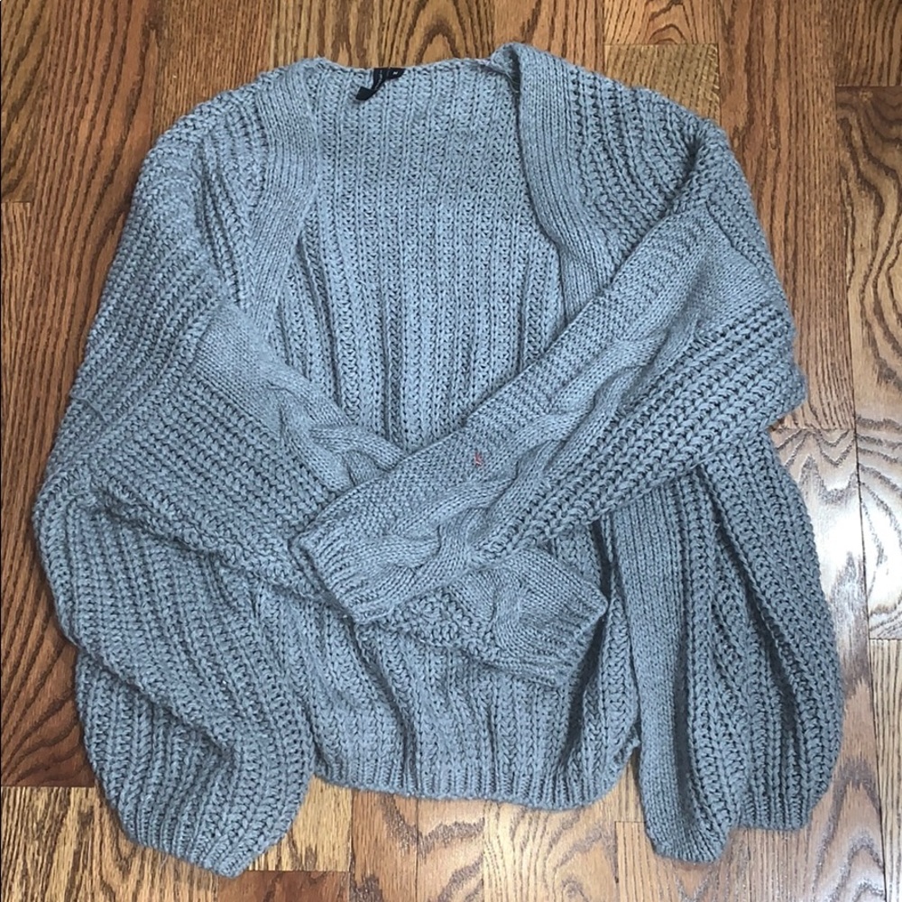 Grey cardigan with grey designs on the sleeves